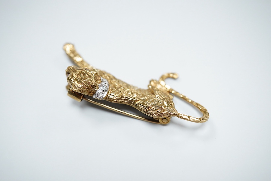 Two 9ct gold brooches, one designed as a collared leopard, its eyes set with rubies, length 5.2cm; the other designed as a hummingbird in flight, its eye set with an emerald, length 4.9cm, each in textured 9ct gold, Brit